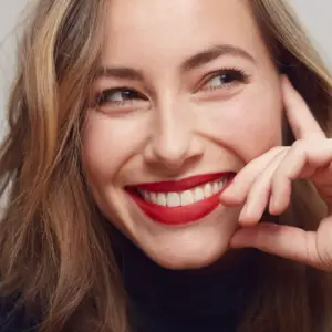 young women with red lipstick smiling