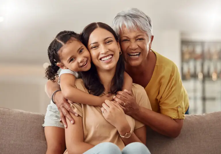 Grandma, mother, and daughter smiling