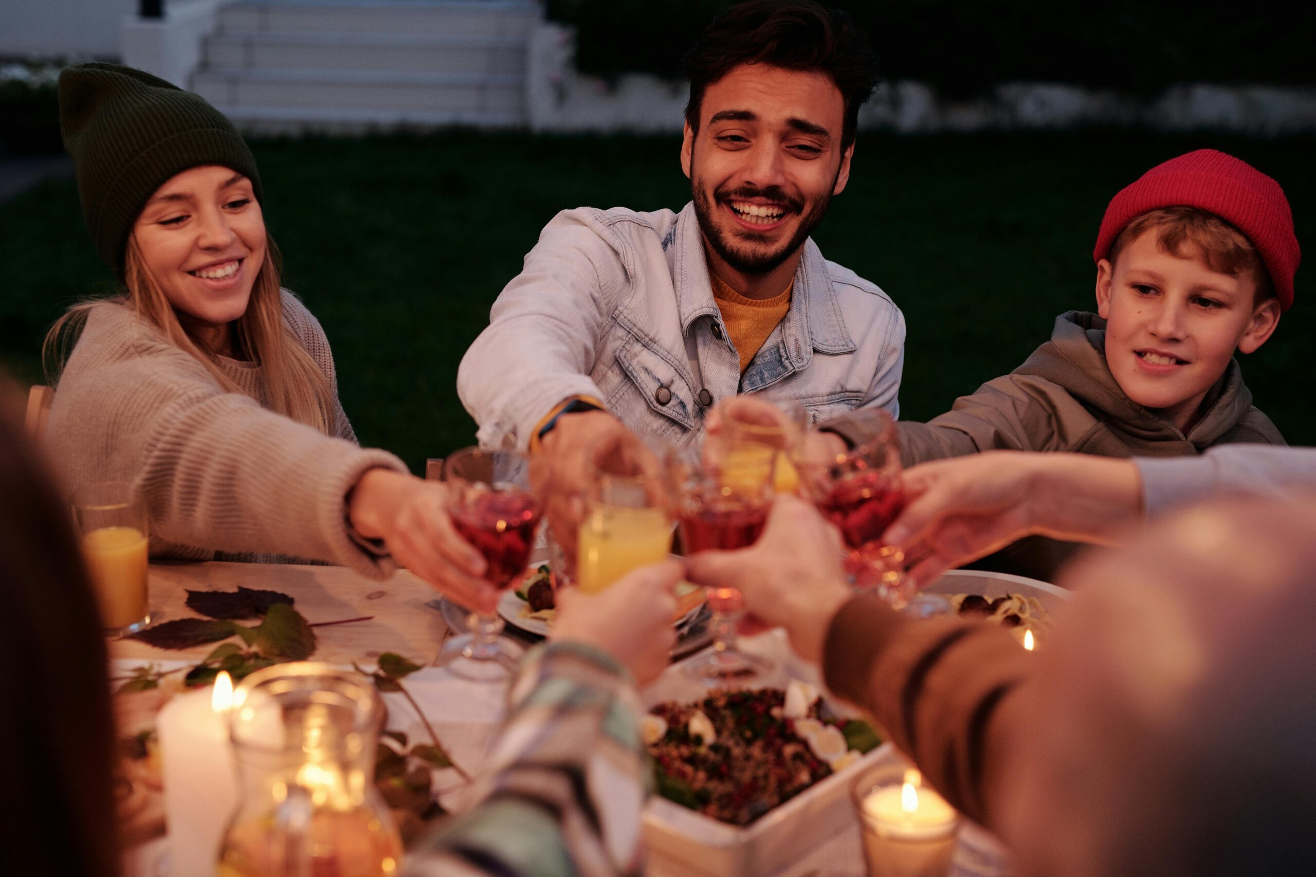 group of friends smiling and toasting after getting Invisalign and teeth whitening in Tigard, Oregon